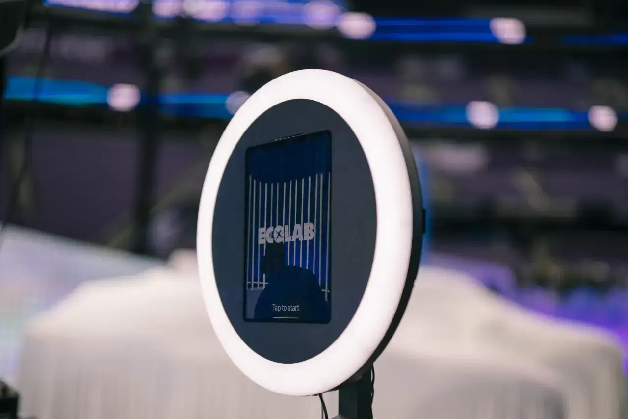 CrowdPass photo booth with ring light and branded Ecolab screen at stadium event